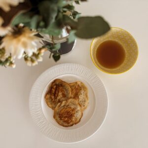 Eggless pancakes with side of maple syrup.