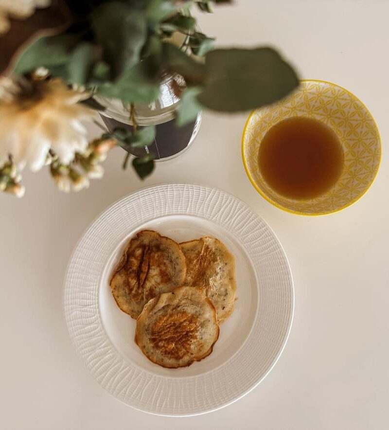 Eggless pancakes with side of maple syrup.