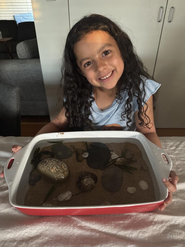 10 engaging nature activities for kids ages 4-6 years old: create a miniature rockpool - pictured: my 6 year old and her rockpool.