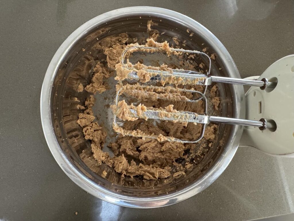 Delicious eggless choc chunk cookies: butter and coconut sugar beaten well with electric mixer.