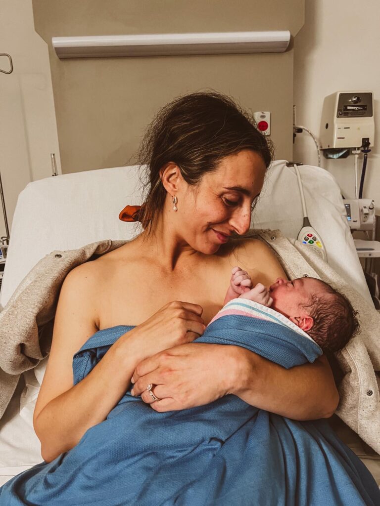 How to support your gut after antibiotics use during labour: 40 minutes after I gave birth to my third baby, holding him and smiling at him.