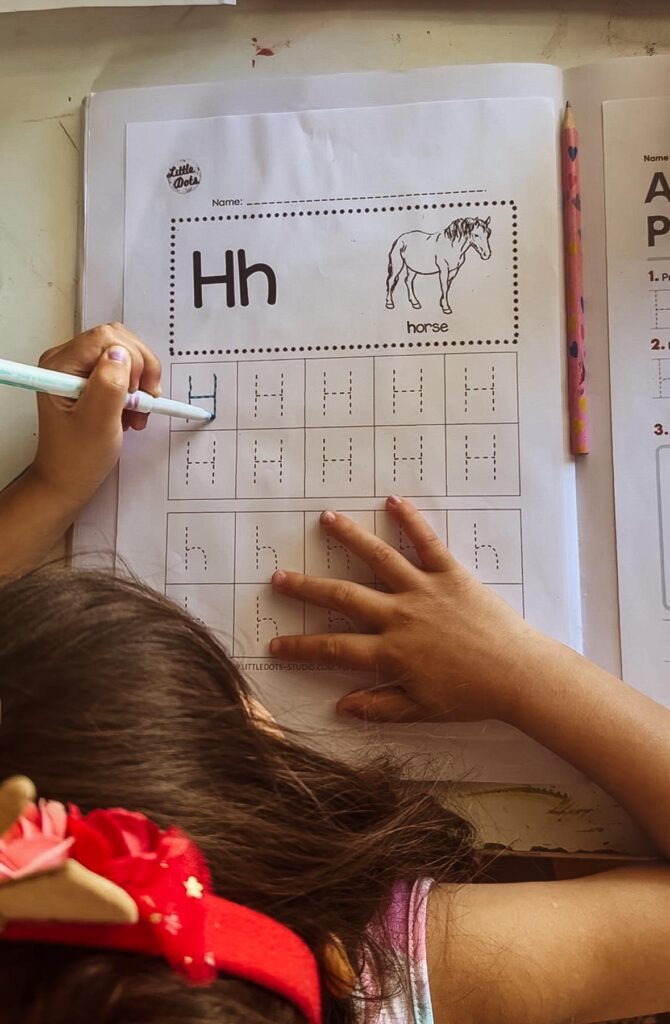 A day in the life of an Australian homeschooling family: my daughter completing her letter tracing.