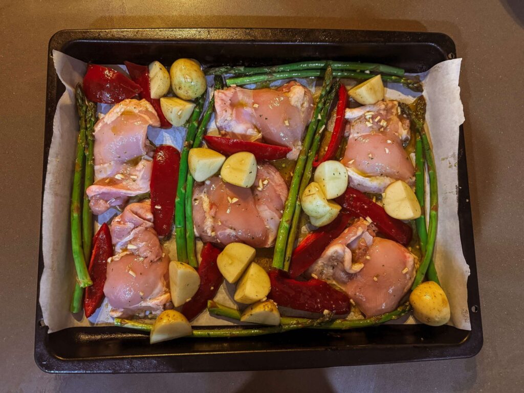 Mediterranean Chicken Tray Bake ingredients assembled on pan