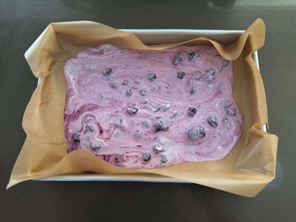 Gut-friendly yoghurt unicorn slices for kids: pour blueberry mix into prepared dish