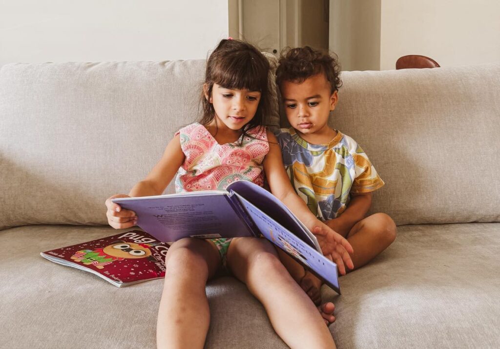 Our first year of homeschooling in a nutshell: sister and brother reading a book