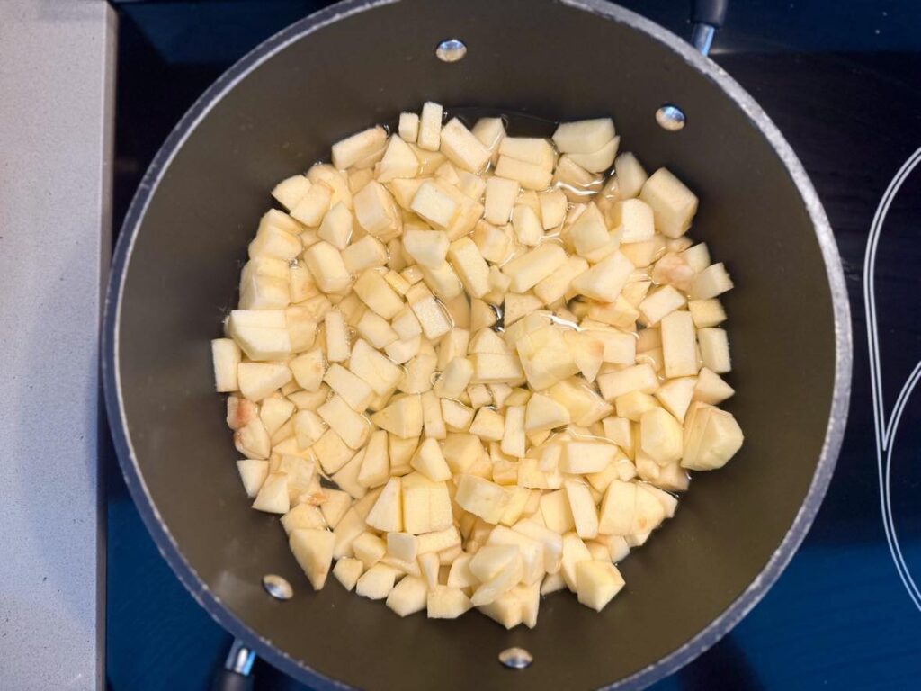 Healthy homemade applesauce for kids: heat apples and water over stovetop