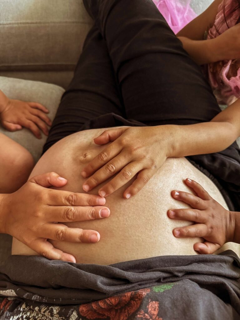 10 myths about pregnancy nutrition: siblings touching mother's pregnant belly